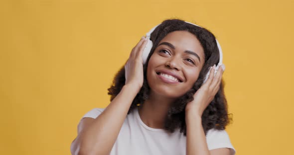 African American Girl Enjoying Favorite Music in Headphones