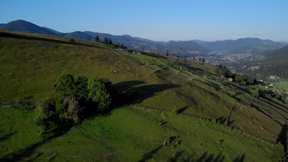 Mountain Valley with Green Fields and Meadows