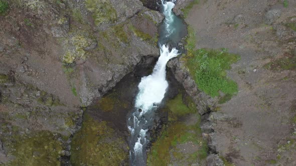 Waterfalls in Iceland that are stacked up with drone video moving down.