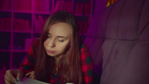 A Beautiful Student Reading a Big Book