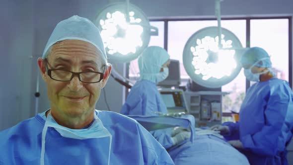 Front view of active Caucasian senior man standing in operation theater