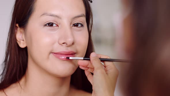 Young asian woman in bedroom. Make-up artist in beauty studio