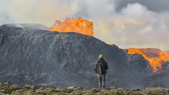 Man Walking Near Erupting Fagradalsfjall Volcano In Reykjanes Peninsula Iceland