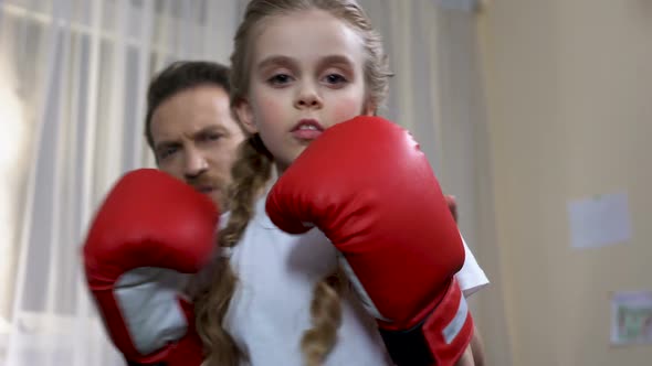 Boxing School Girl Practicing Punches With Father at Home, Self-Defense Lesson