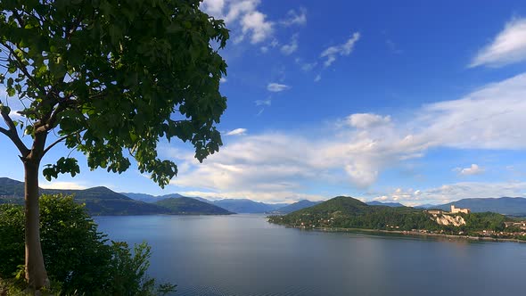 Stunning time-lapse of Maggiore lake with Angera castle and Alps mountain range in background, Italy