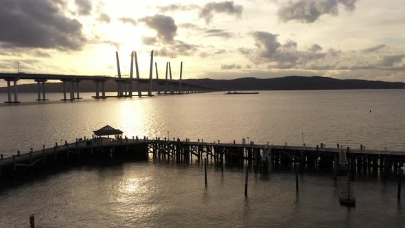 An aerial shot over the Tarrytown Marina with the Mario M. Cuomo Bridge in the background. The drone