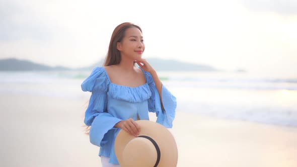 Asian woman enjoy around beautiful beach sea ocean