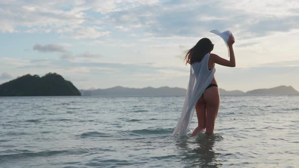 Young Woman In Thong And Sun Hat In Sea