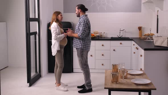 Couple Expecting Baby Quarreling in Home Kitchen