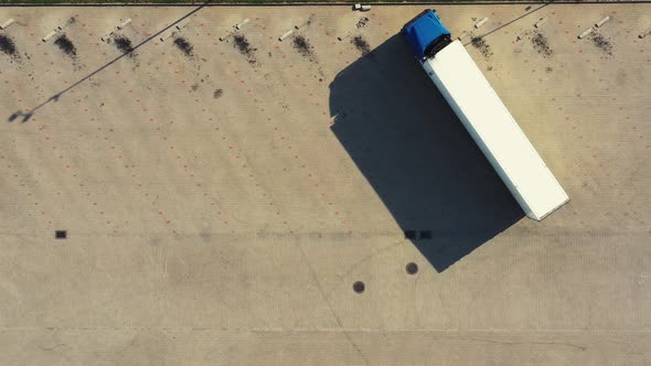 Aerial view of a semi-trailers trucks standing at the warehouse ramps for load unload goods in the l