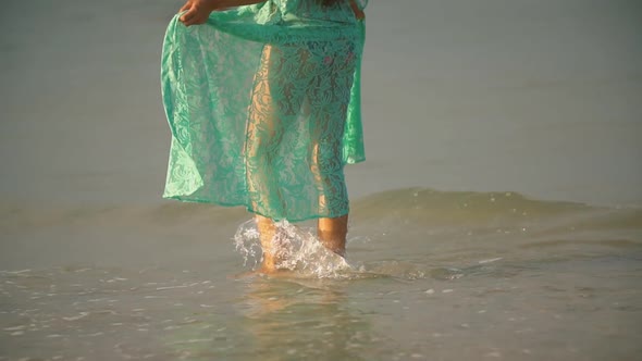 Woman in a Bathrobe Walking Along the Sea