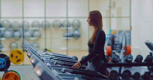Young Woman Doing a Workout on a Treadmill