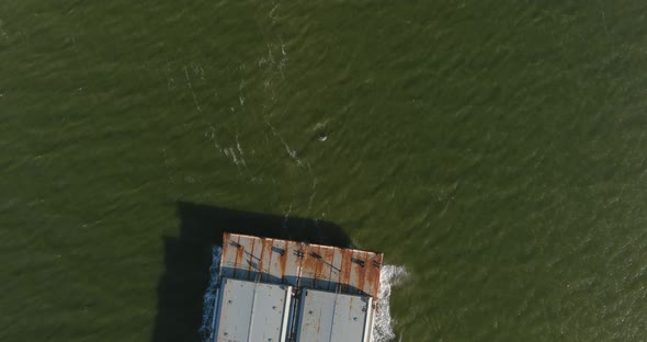 Aerial establishing shot of large tanker boat in water