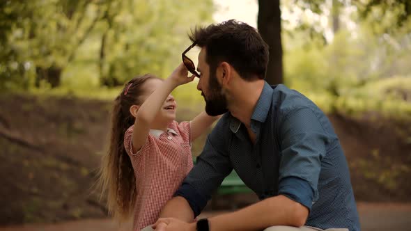 Cute Kid Wearing Sunglasses To Father. Children Enjoy Playing Funny Activity Together With Father.