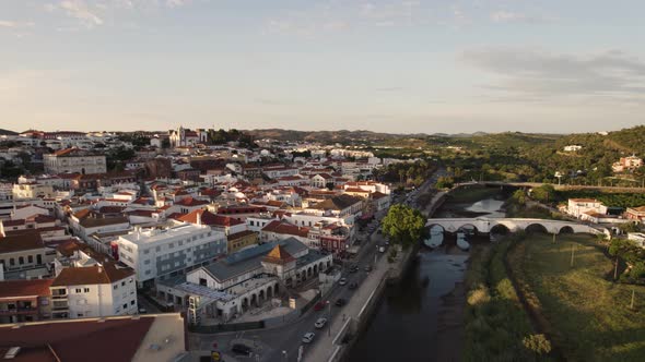 Low flying aerial of the vivid streets of Silves and the Arade river in Portugal