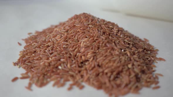 Raw Red Rice on the Table. Concept: Footage for the Recipe. . Food Video