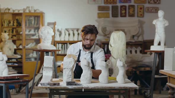 Male Master with Beard which Using Hammer and Chisel Creating Details of Limestone Work