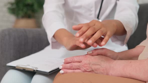 Afro American Woman Doctor Supports Senior Woman Holding Her Hands