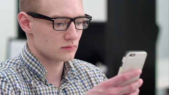 Serious Office Worker Using Mobile Phone