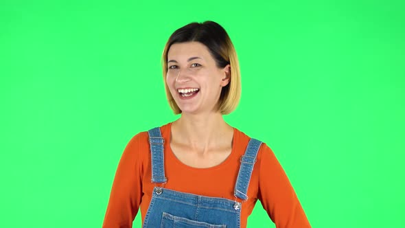 Girl Shows Two Fingers Victory Gesture. Green Screen