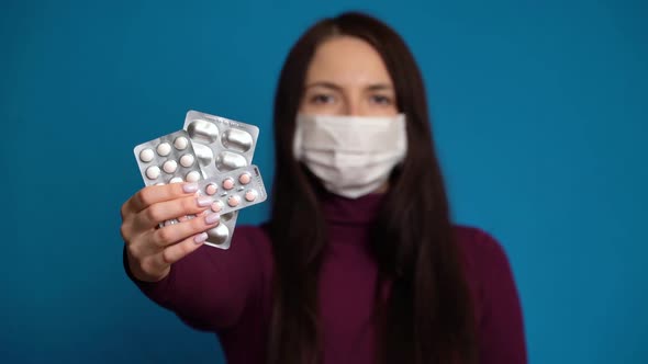 Woman Presenting a Hand Pills