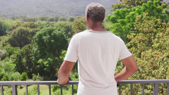 Senior African American man looking at the view on his balcony