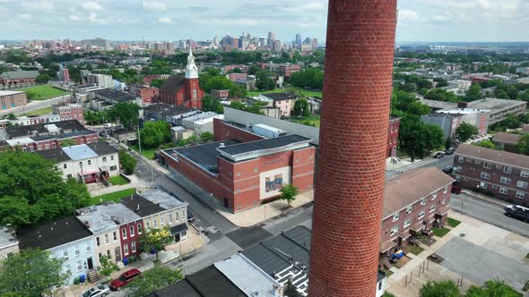 Neighborhood inner city ghetto, aerial rises to reveal urban skyline.