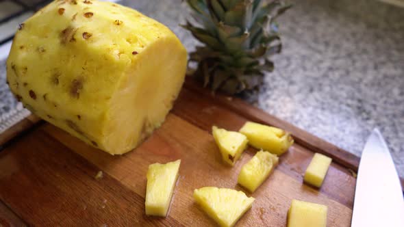 Fresh Pineapple Fruit Peeled And Cut On Wooden Board. dolly-out