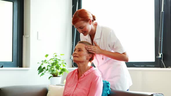 Nurse doing facial massage to her senior patient