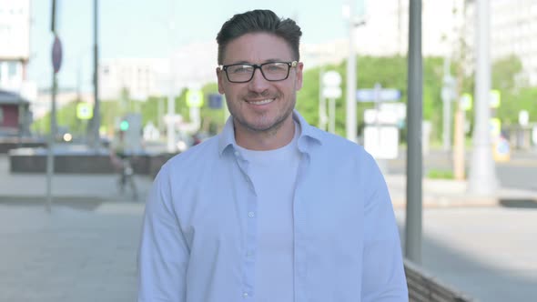 Portrait of Man Smiling at Camera Outdoor