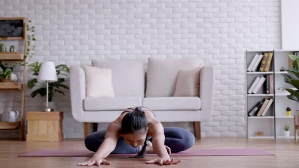 Asian woman pilates exercise yoga at home.