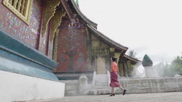 Lao Girl Walking At Wat Xieng Thong Landmark In Luang Prabang