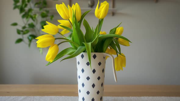 Drooping Yellow Tulips In Flower Vase Rising. zoom-out, hyperlapse