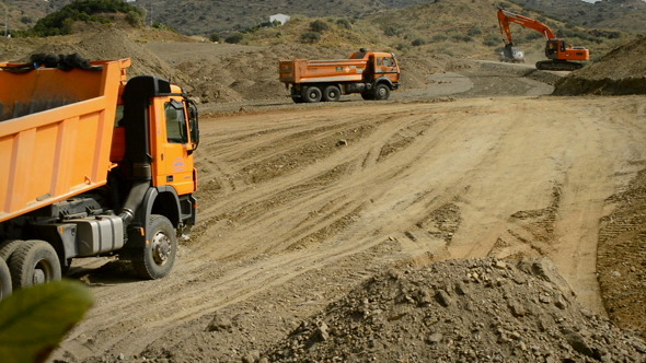Trucks and Excavator Working