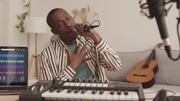 Male African Singer Singing in Microphone in Studio