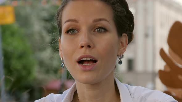 Beautiful Young Woman Having a Casual Business Meeting in an Outdoors Restaurant