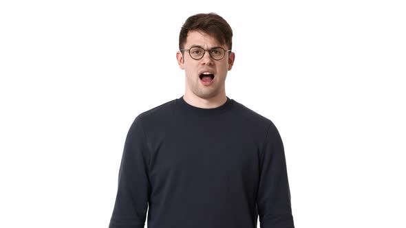 Portrait of Displeased Man Wearing Black Sweatshirt and Eyeglasses Screaming and Covering Mouth in