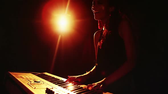 Woman playing electronic keyboard