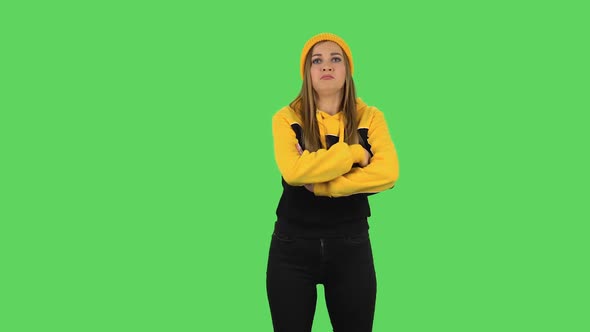Modern Girl in Yellow Hat Is Standing Offended and Then Smiling. Green Screen