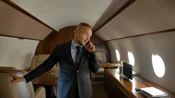 Businessman Talk By Phone Indoor of Private Jet Cabin