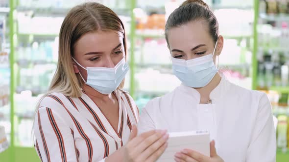 Professional Pharmacist Helping Her Female Customer Choosing Products at the Drugstore