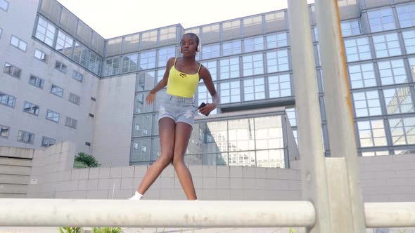 Slow motion shot of young woman dancing in front of house