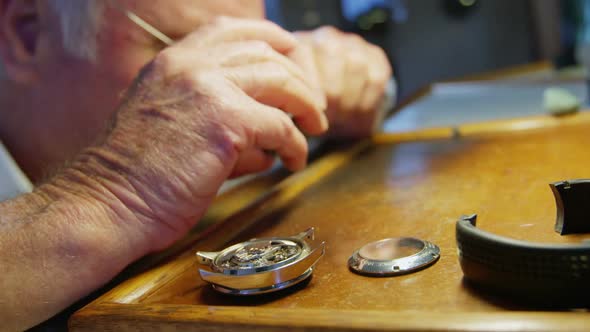 Close-up of horologist repairing a watch