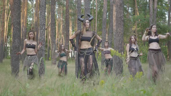 Group of Women Dancers with Make-up and in Mystical Fabulous Costumes Dancing Groovy Dance in Color