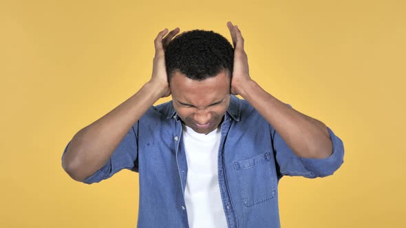 Young African Man with Headache, Yellow Background