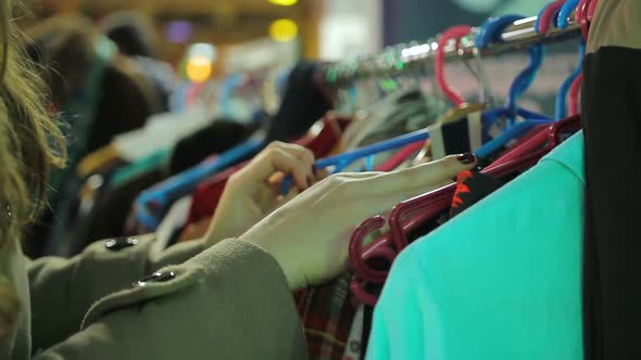 Female Customer Looking at Clothing Exhibition Organized by Local Manufacturers