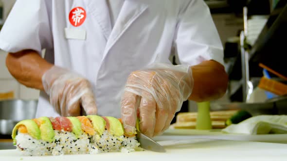 Male chef preparing sushi in kitchen