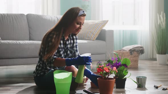 Woman Florist Is Spraying Water On Plants