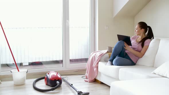 Woman with Tablet Pc and Coffee After Cleaning 