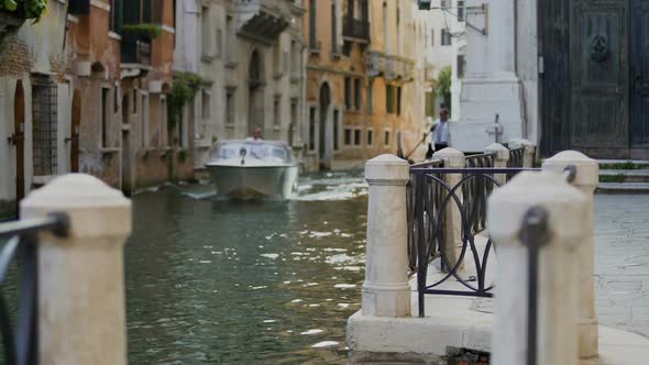 Water Taxi Motorboat Passing Elegant Buildings in Narrow Venice Street, Italy